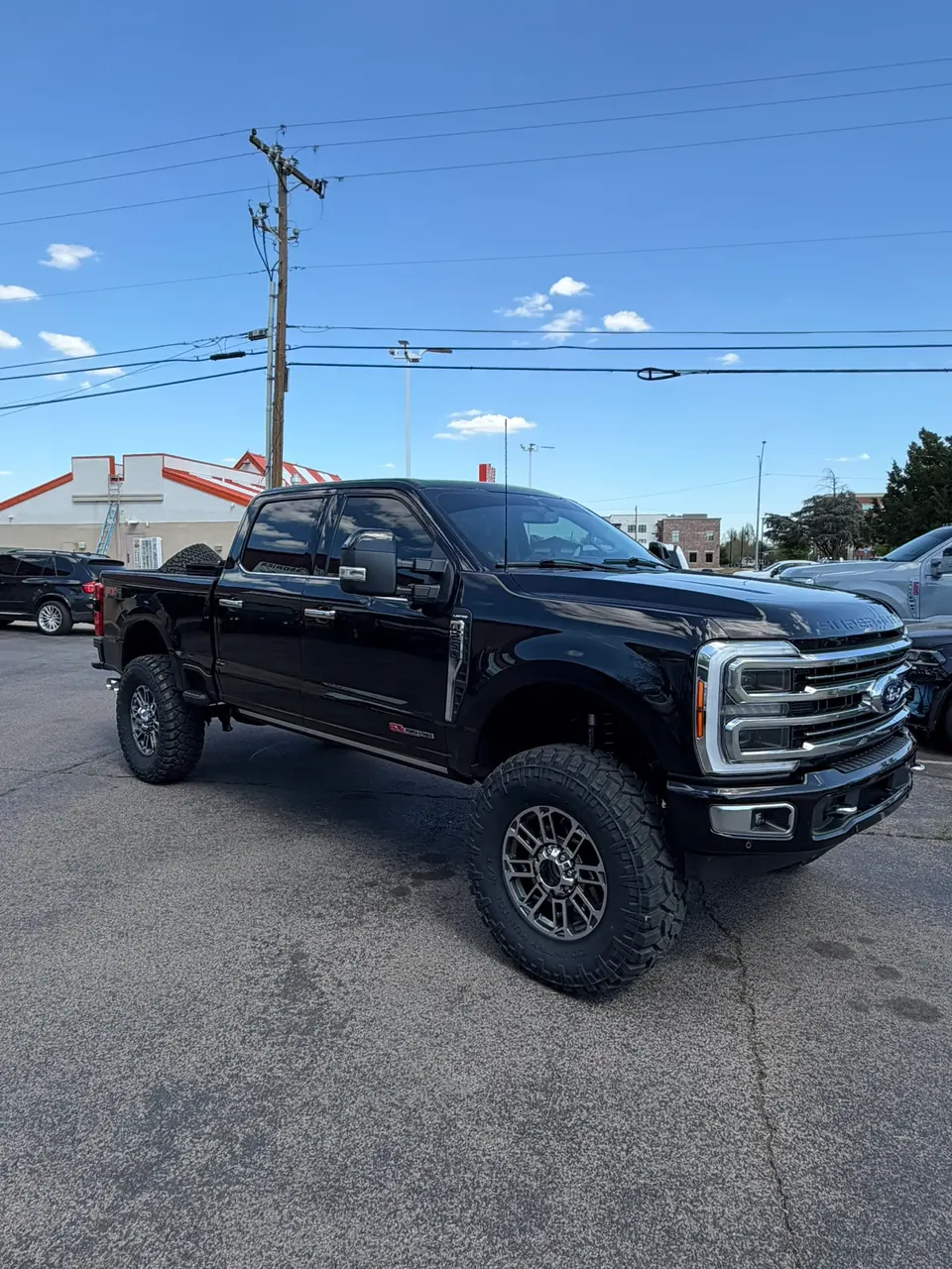 Lifted black Ford F-250 SuperDuty Limited on 37 inch tires