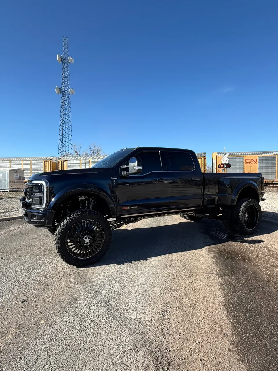 Lifted black Ford F-450 Platinum dually on American Force wheels